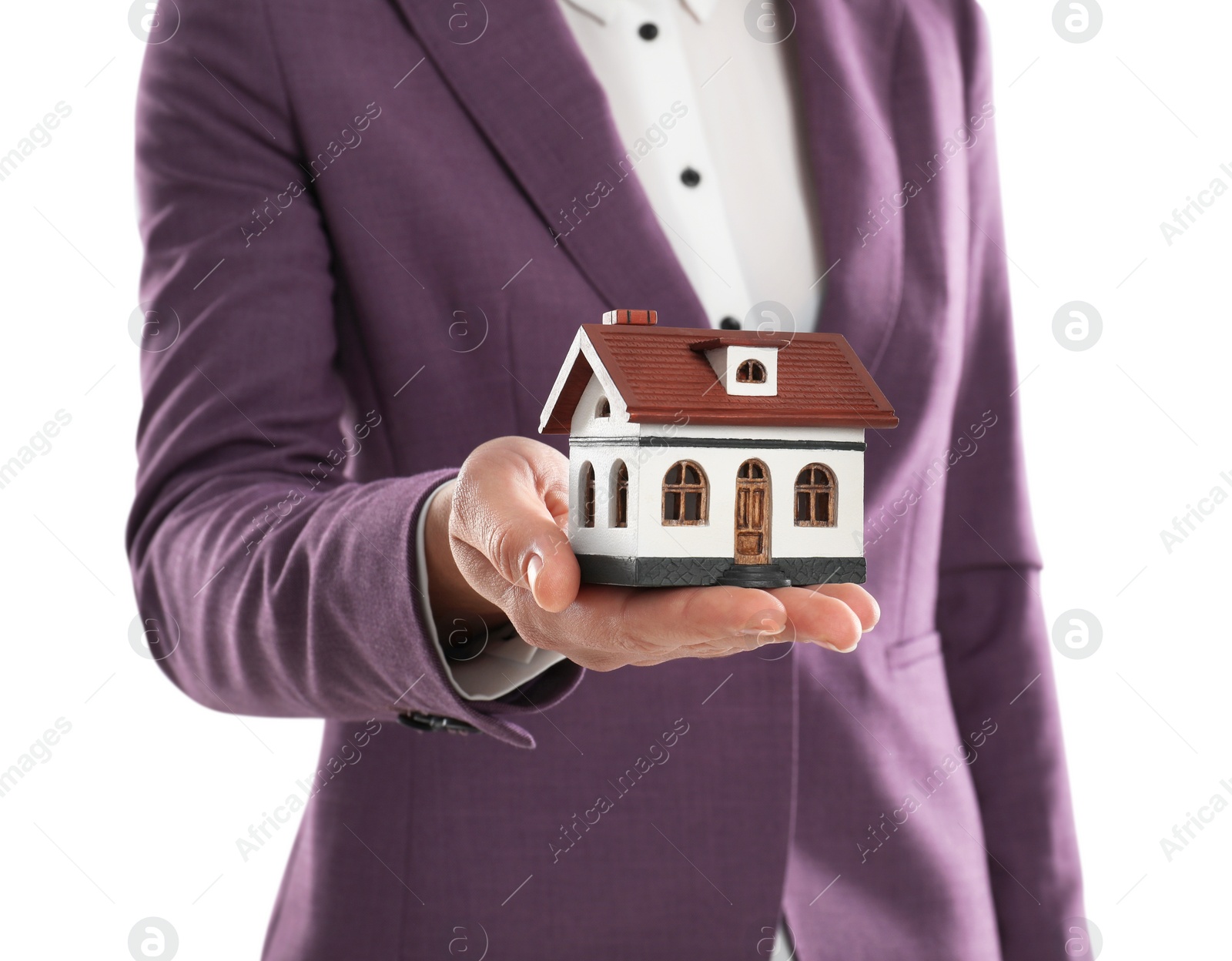 Photo of Real estate agent holding house model on white background, closeup