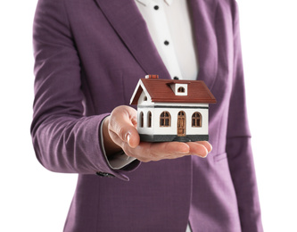 Real estate agent holding house model on white background, closeup