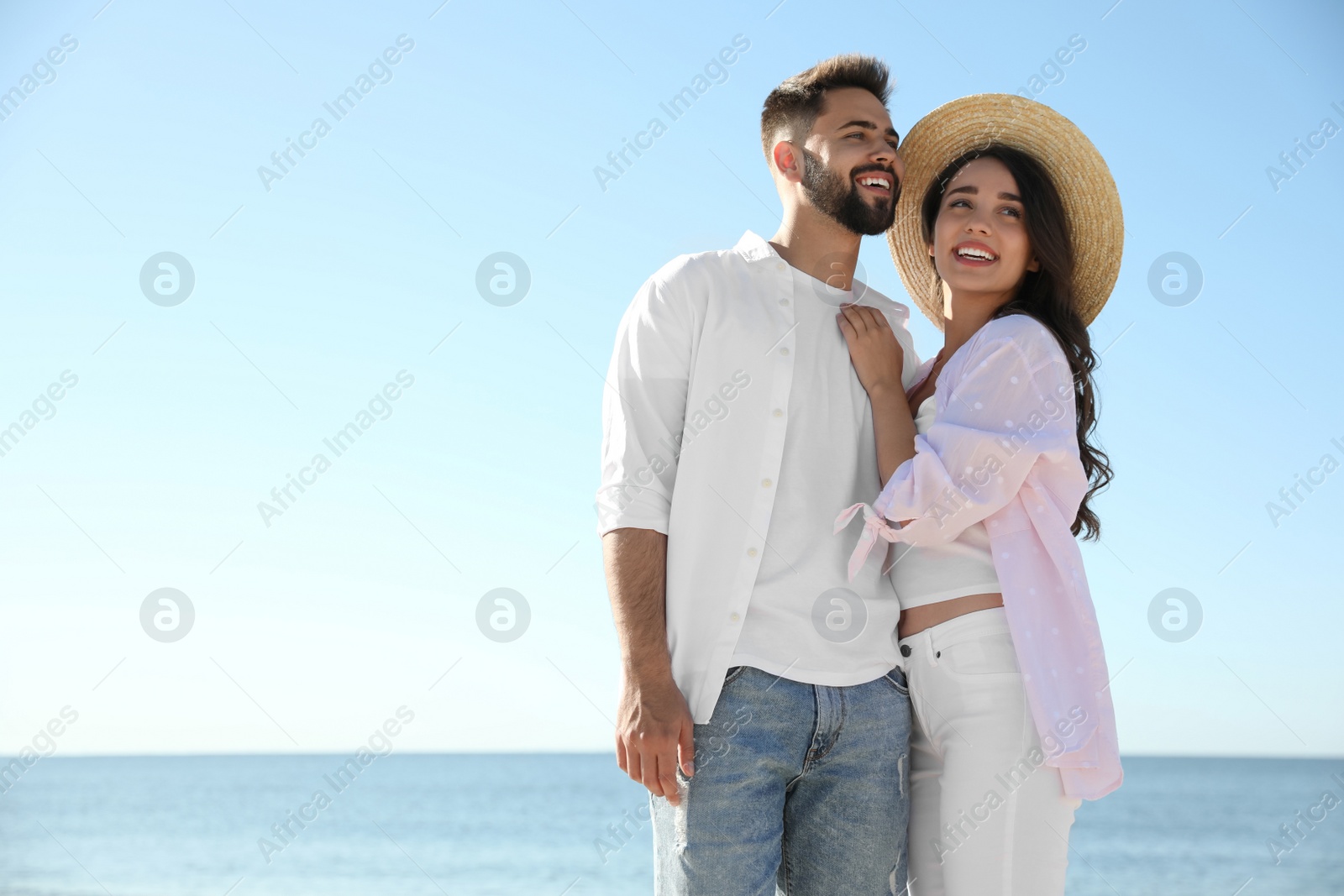 Photo of Happy young couple at beach. Honeymoon trip