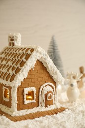 Beautiful gingerbread house decorated with icing on snow