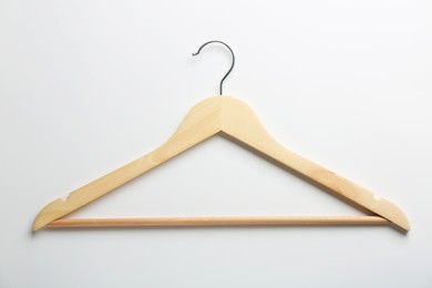 Photo of One wooden hanger on white background, top view