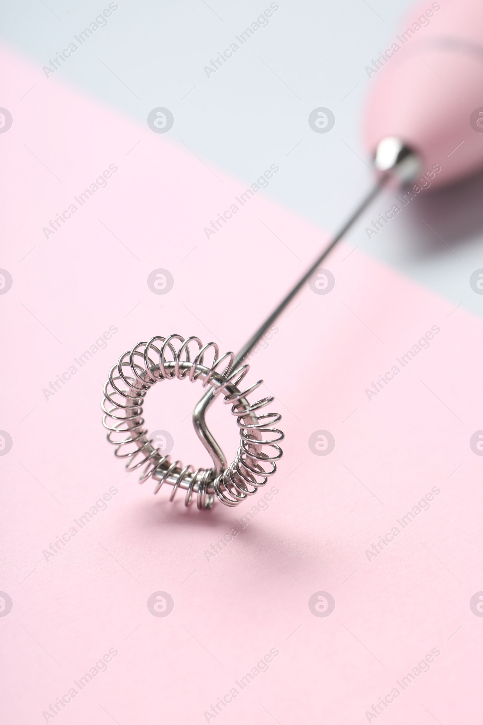 Photo of Pink milk frother wand on color background, closeup