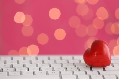 Red decorative heart on laptop, space for text. Online dating