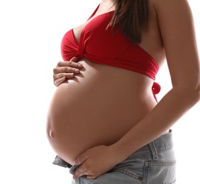 Photo of Young pregnant woman wearing swimsuit on white background, closeup. Sun protection concept