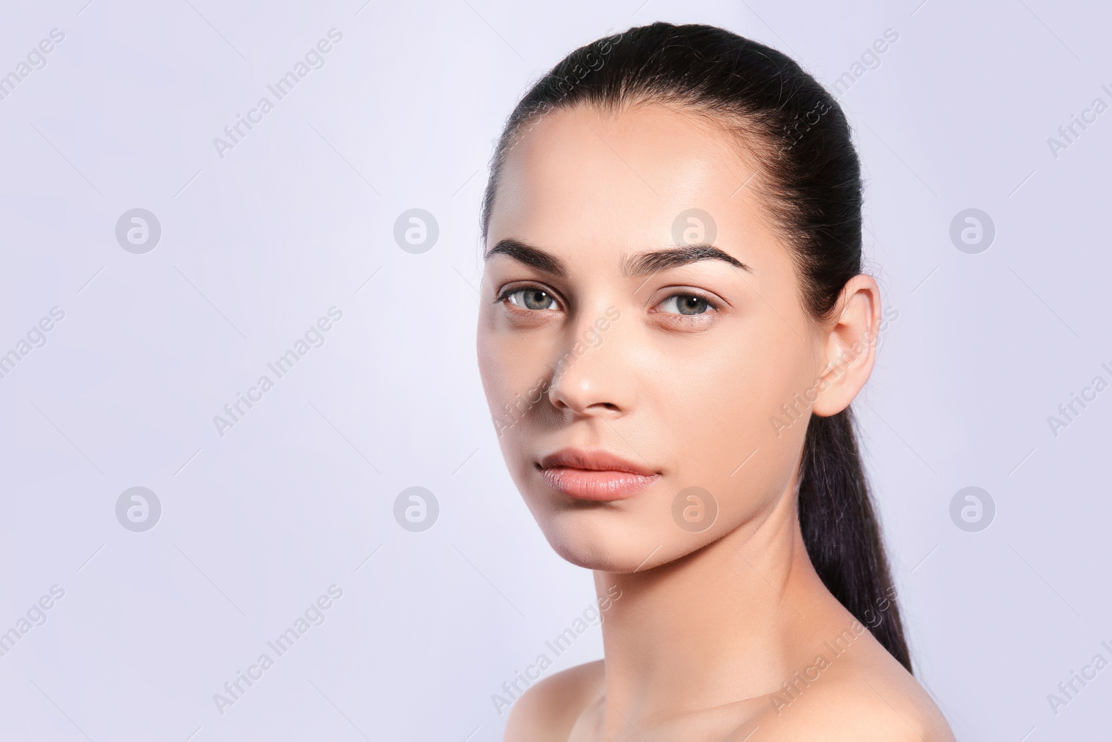 Photo of Beautiful woman with perfect eyebrows on light background