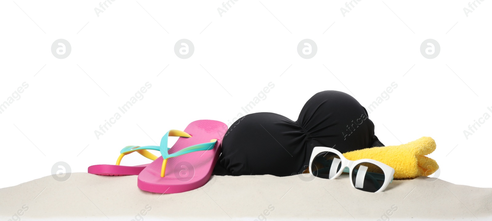 Photo of Different stylish beach accessories on sand against white background