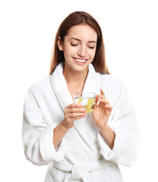 Young woman with glass of lemon water on white background