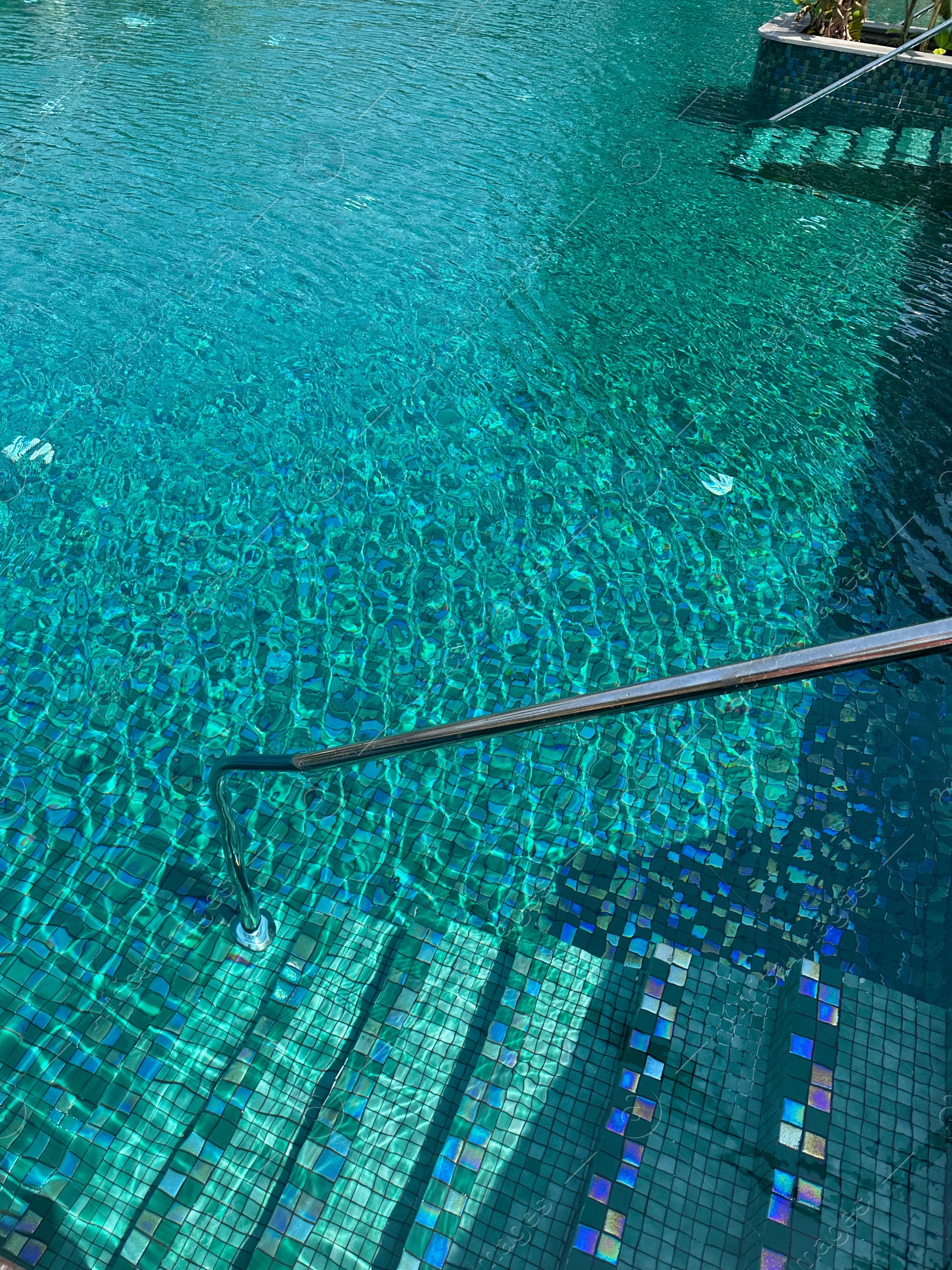 Photo of Metal rail and steps in outdoor swimming pool