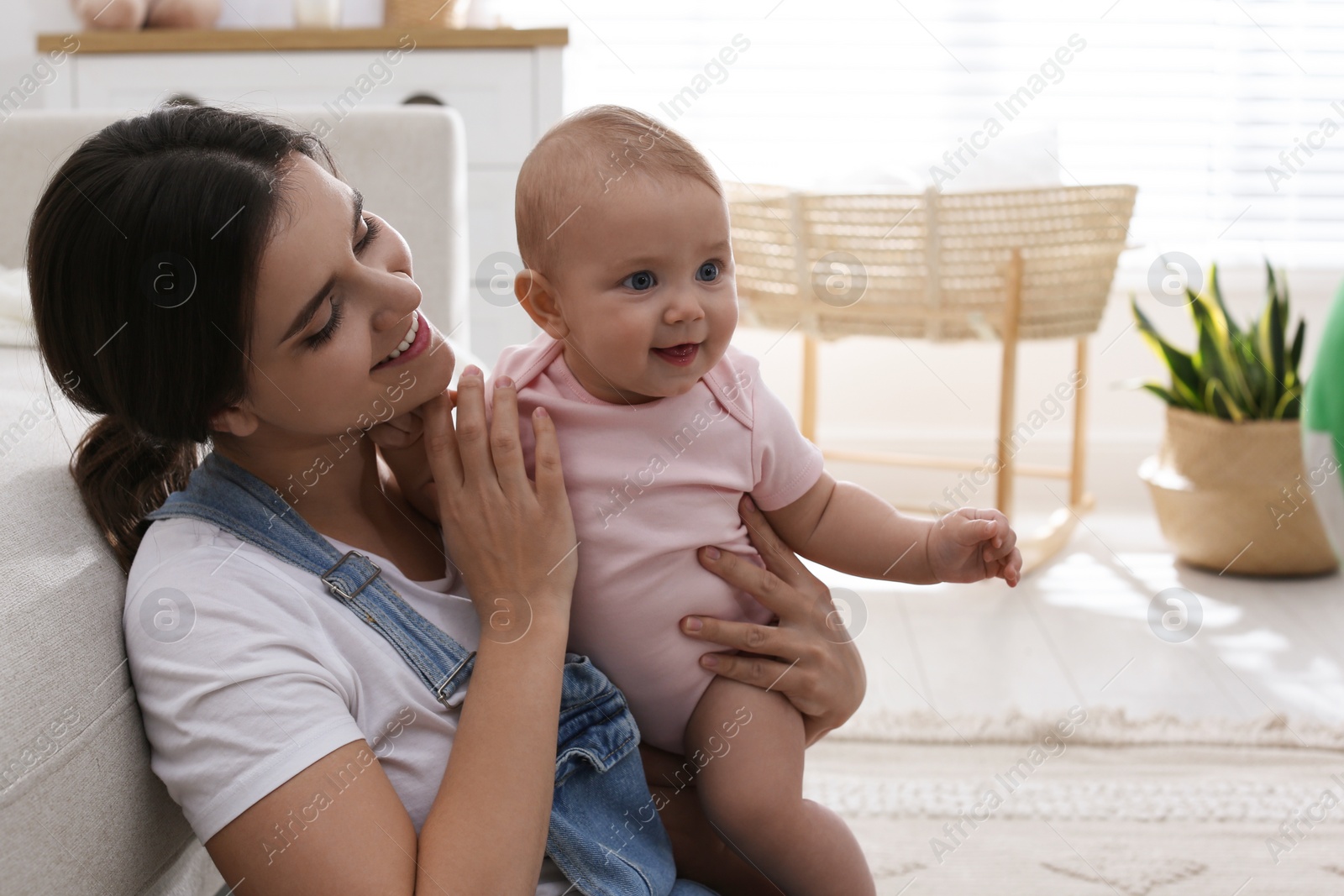 Photo of Happy young mother with her cute baby at home