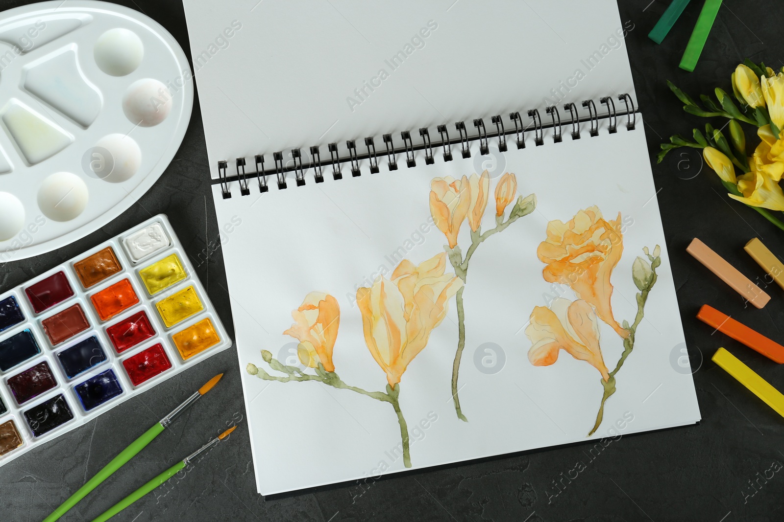 Photo of Flat lay composition with beautiful drawing of freesia flowers on black table