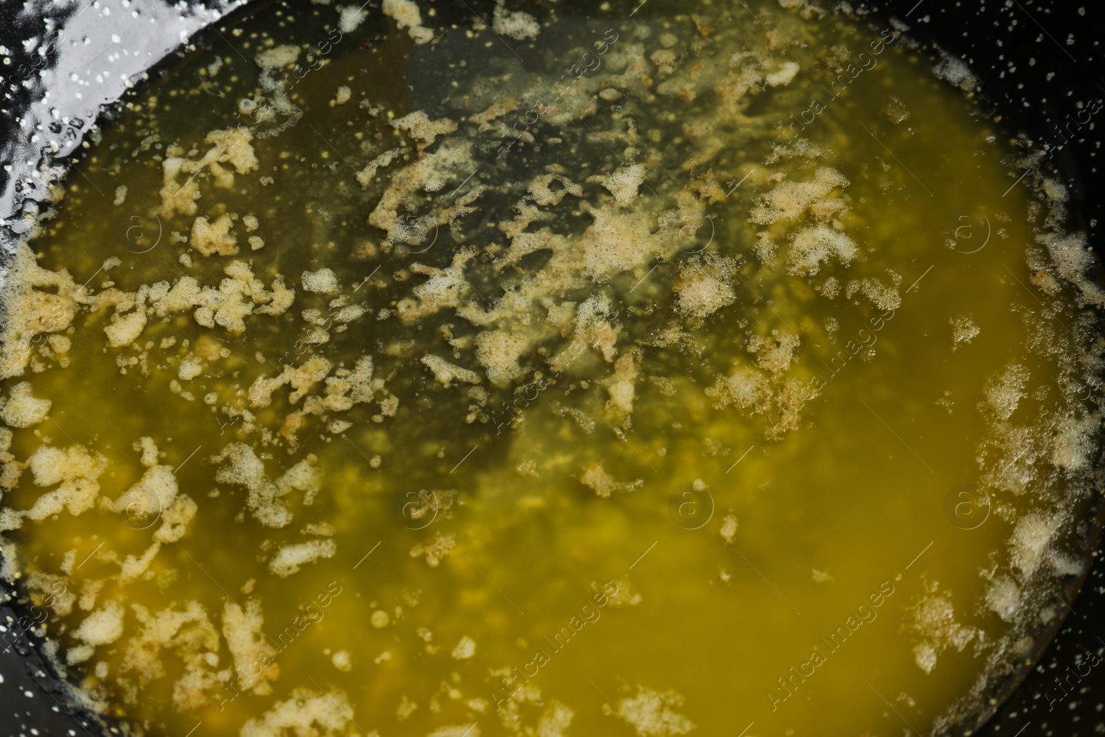 Photo of Tasty melting butter in frying pan, closeup