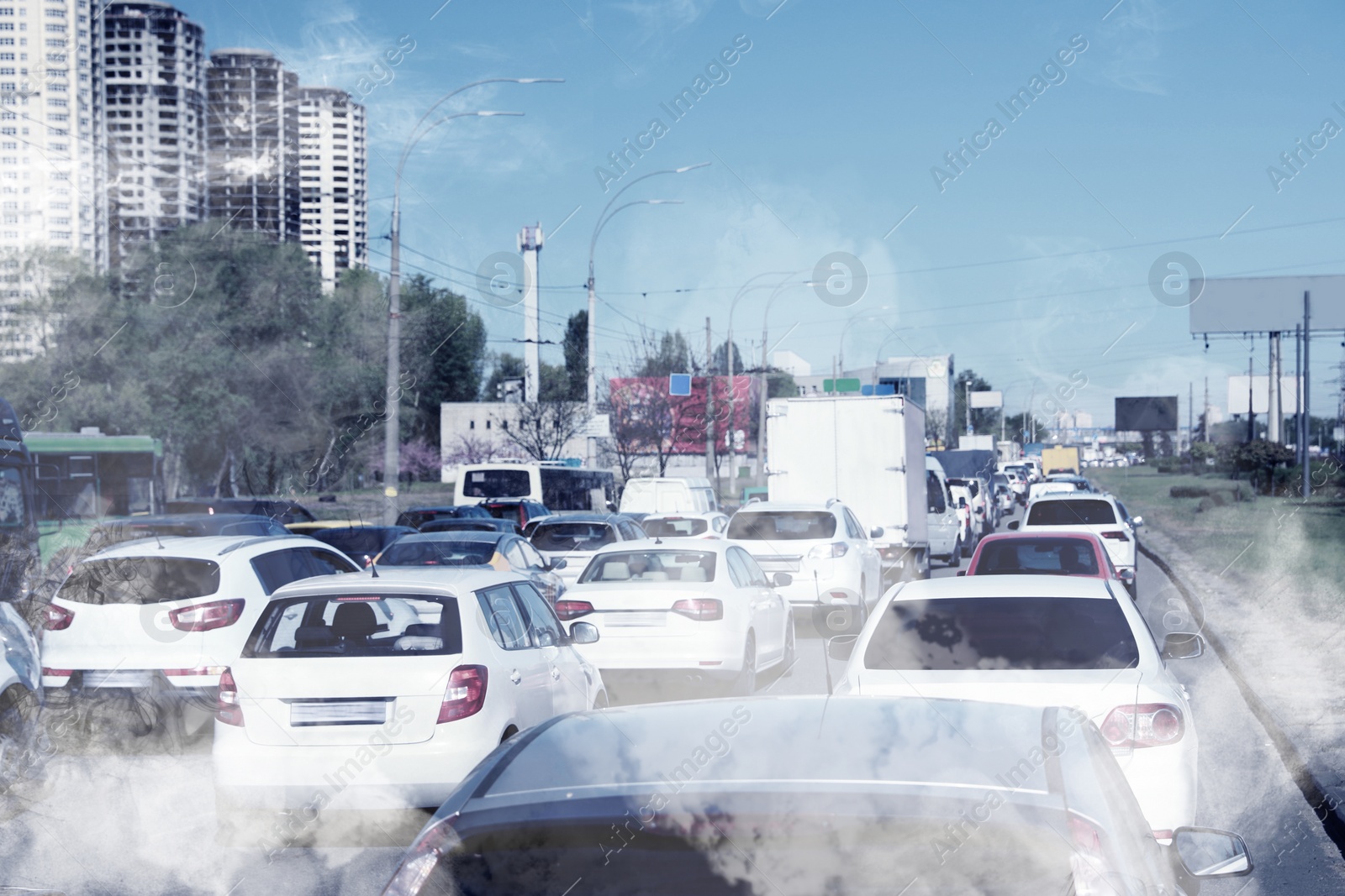 Image of Environmental pollution. Air contaminated with fumes in city. Cars surrounded by exhaust on road