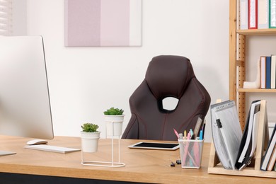 Photo of Desk and comfortable chair in modern office. Interior design