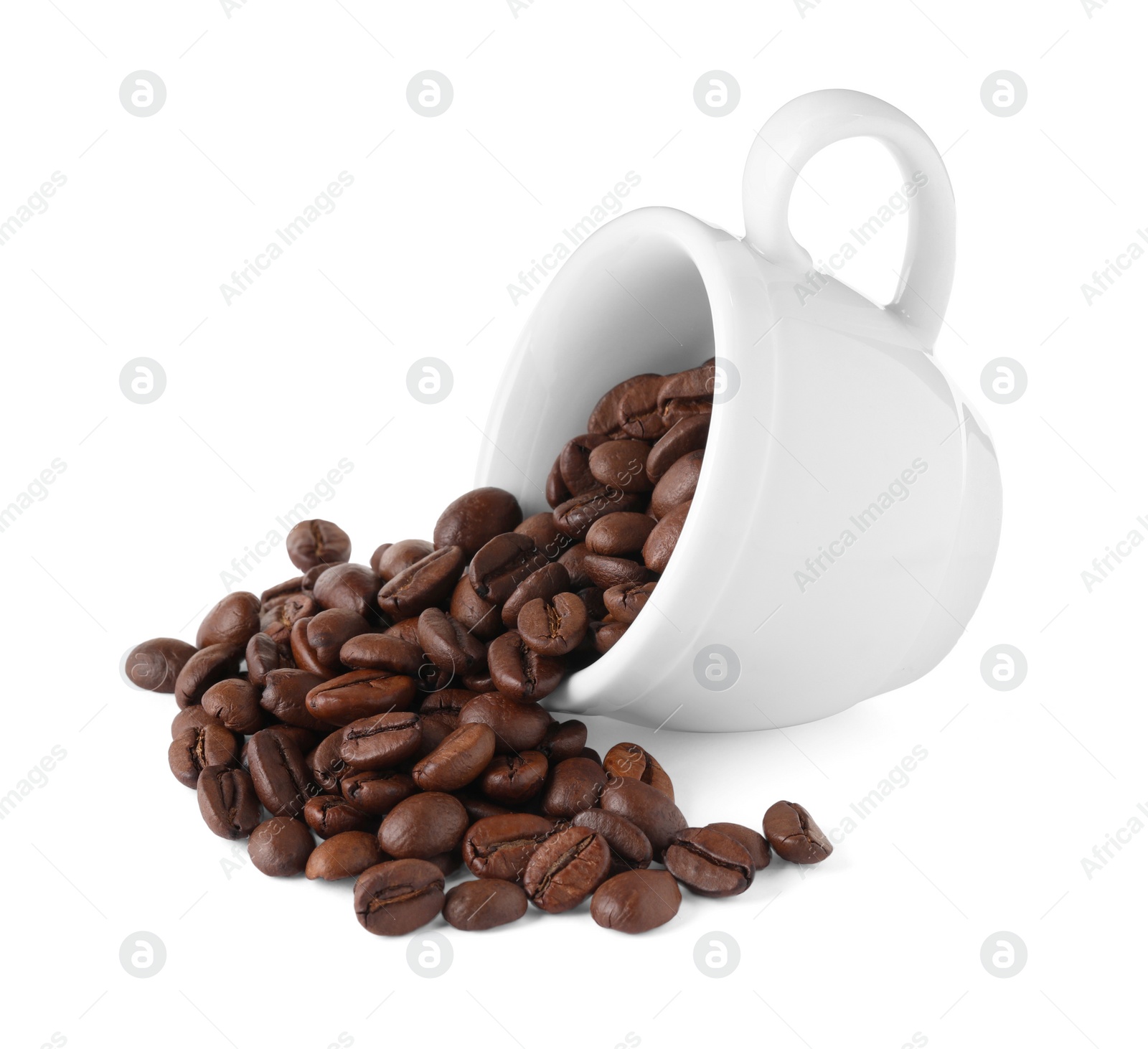 Photo of Coffee beans and overturned cup isolated on white