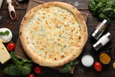 Photo of Flat lay composition with delicious cheese pizza and ingredients on wooden table