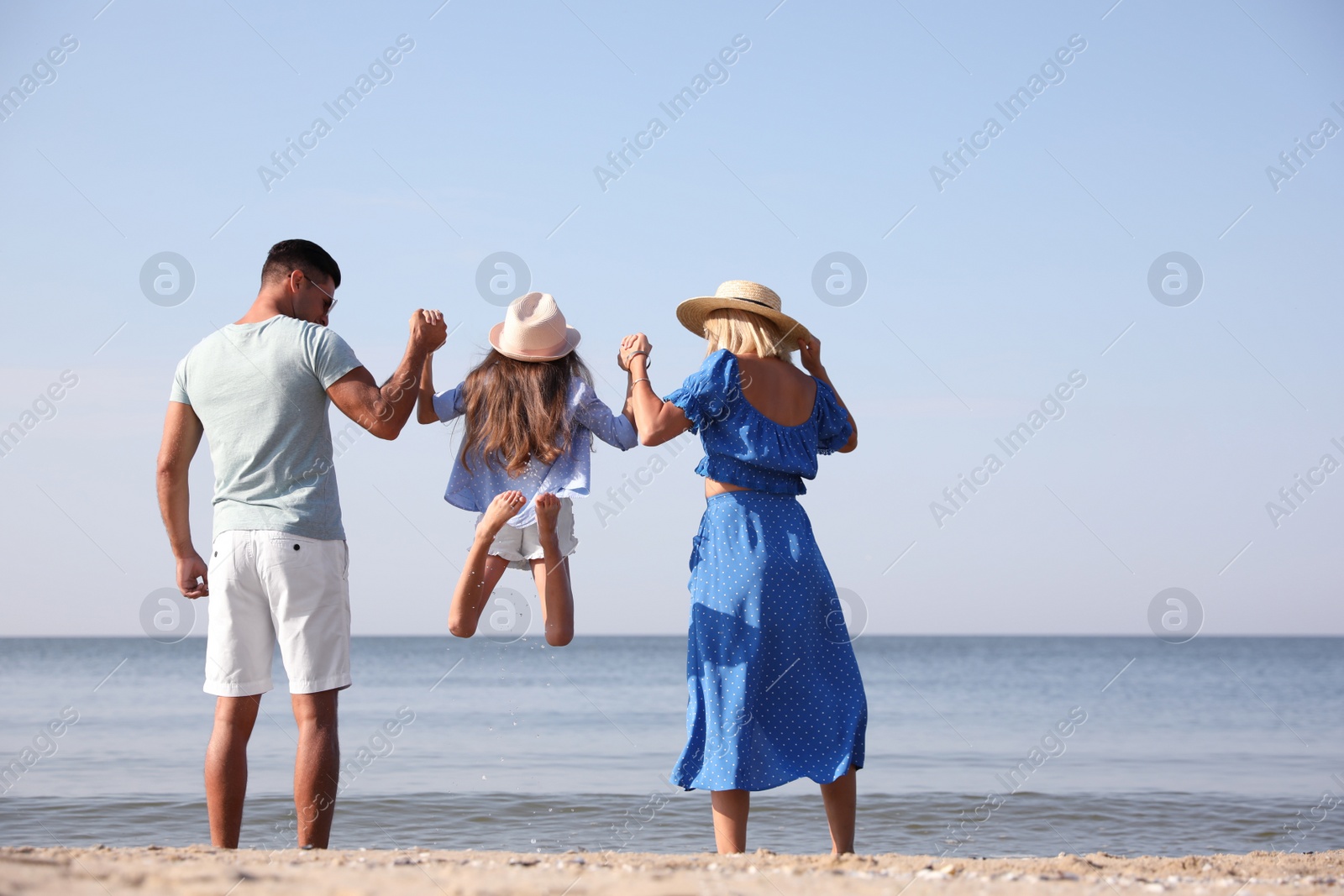 Photo of Family at beach on sunny summer day