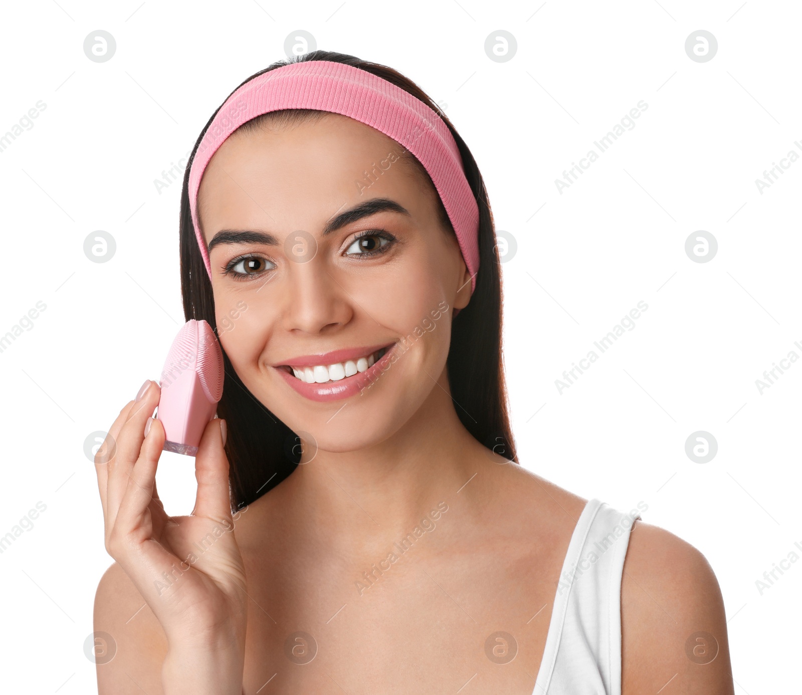 Photo of Young woman using facial cleansing brush on white background. Washing accessory