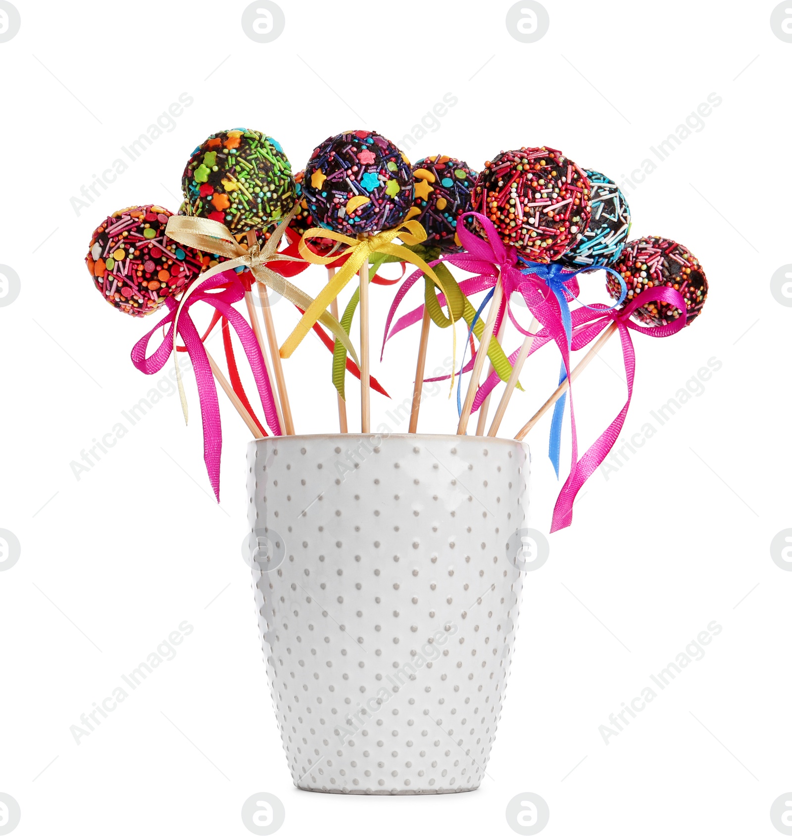 Photo of Sweet cake-pops in glass on white background