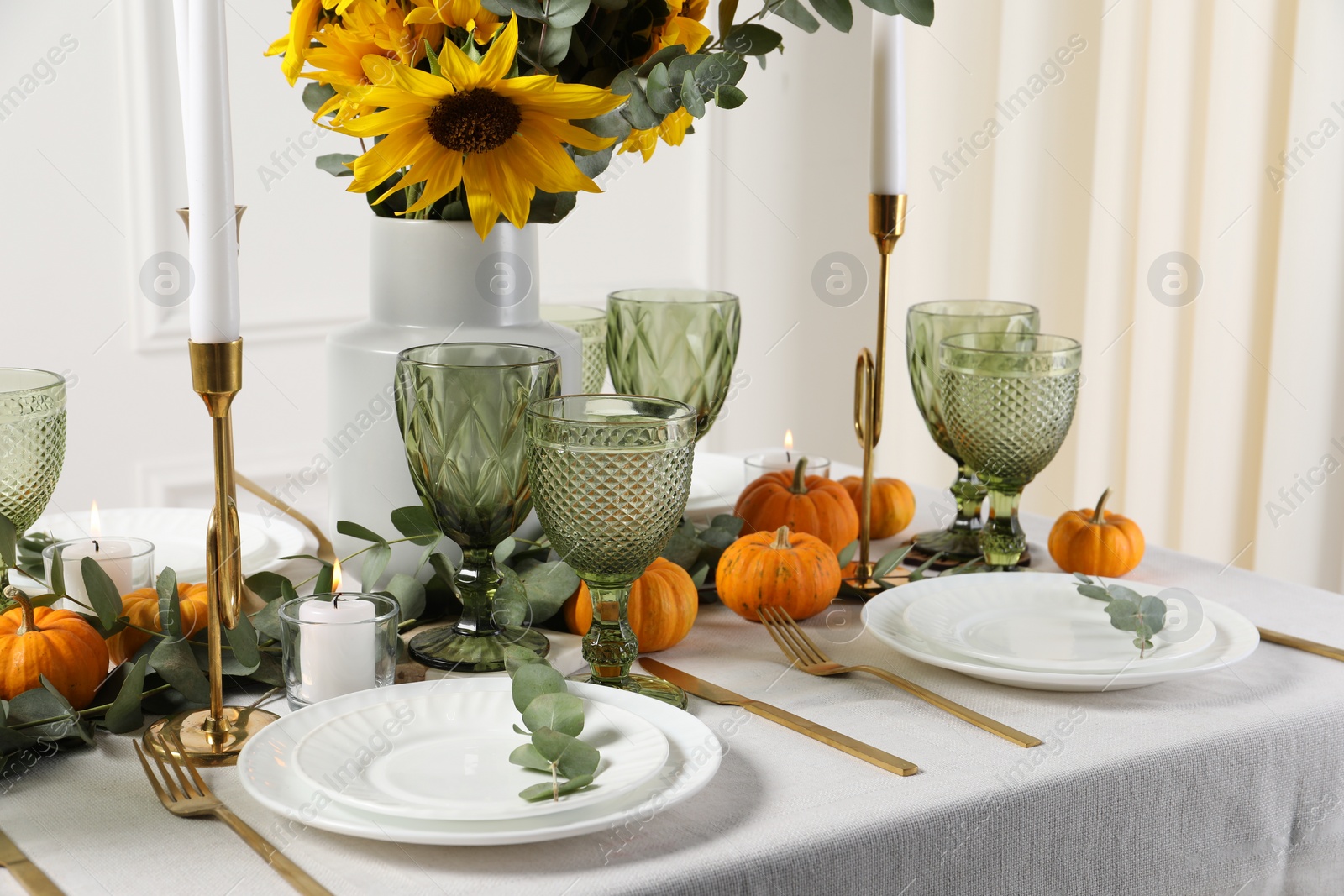 Photo of Beautiful autumn table setting with bouquet indoors. Plates, cutlery, glasses and floral decor