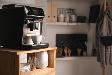 Photo of Modern coffee machine making tasty drink in office kitchen. Space for text