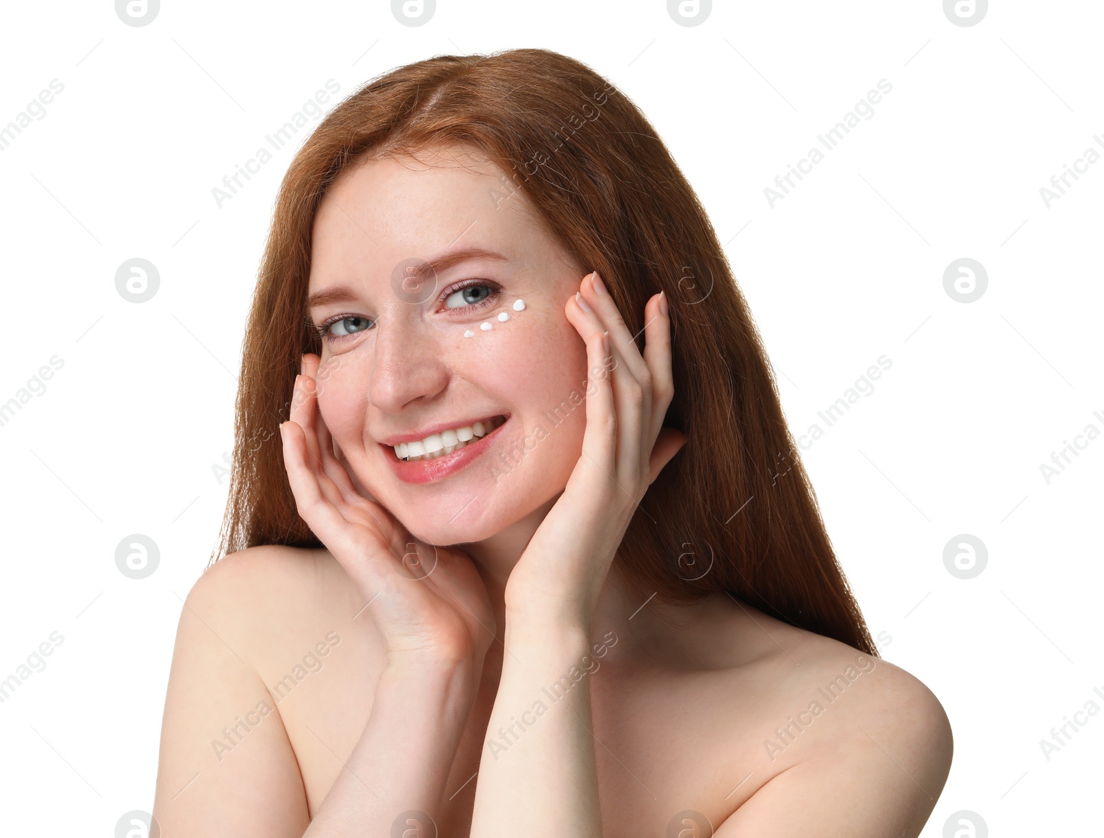 Photo of Smiling woman with freckles and cream on her face against white background