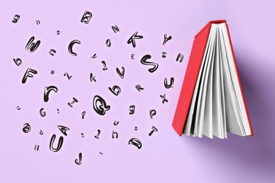 Image of Book and flying letters on lilac background, top view