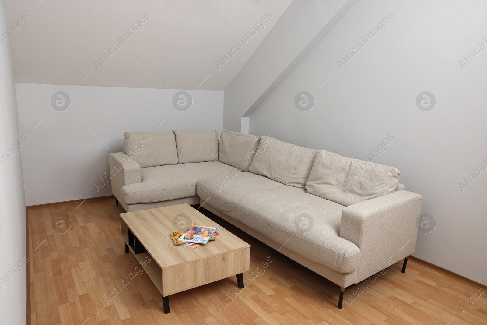 Photo of Attic room interior with slanted ceiling and furniture