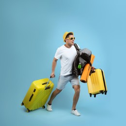 Photo of Male tourist with travel backpack and suitcases running on turquoise background