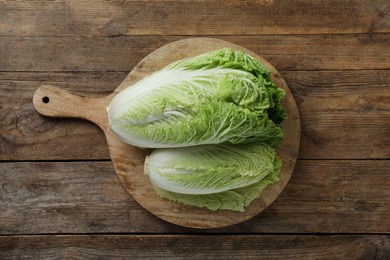 Photo of Fresh ripe Chinese cabbages on wooden table, top view