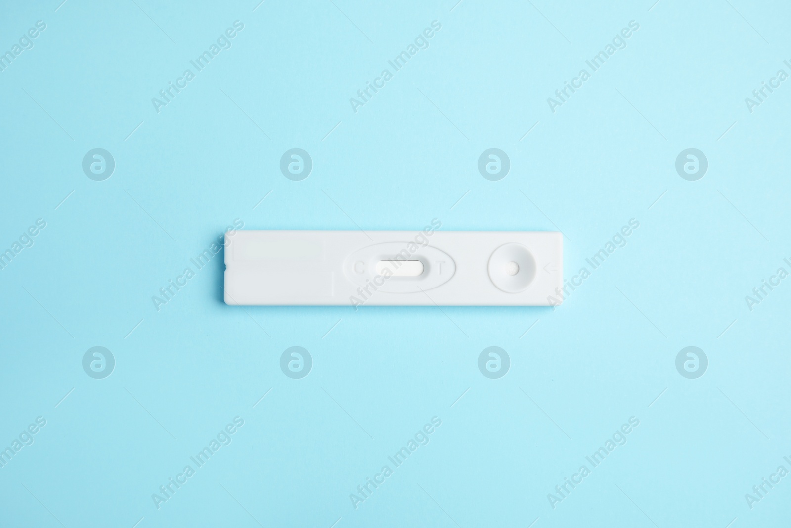 Photo of One disposable express test for hepatitis on light blue background, top view