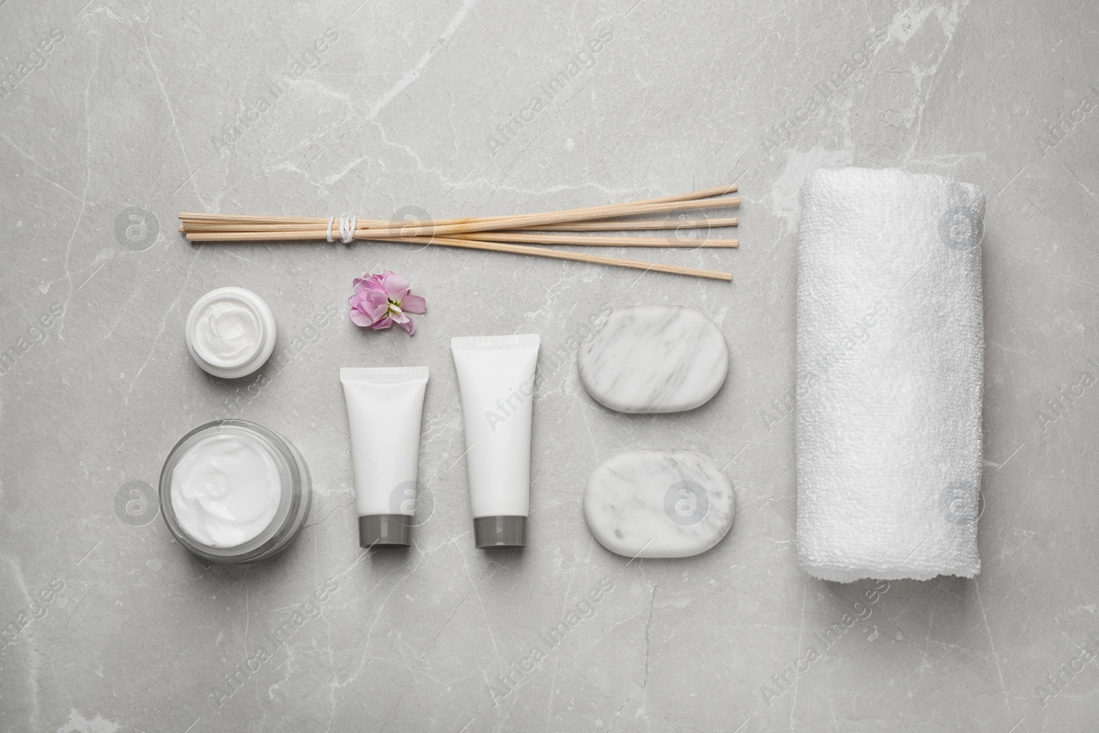 Photo of Flat lay composition with cosmetics on grey marble table. Spa treatment