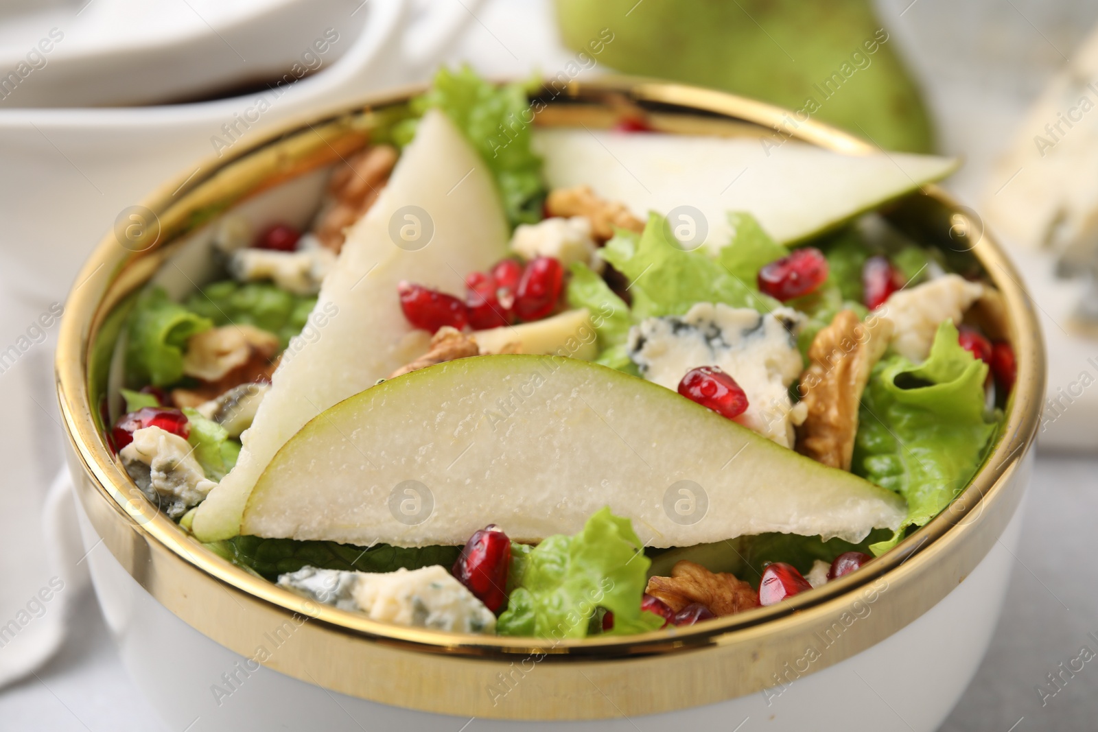 Photo of Delicious pear salad in bowl on table, closeup