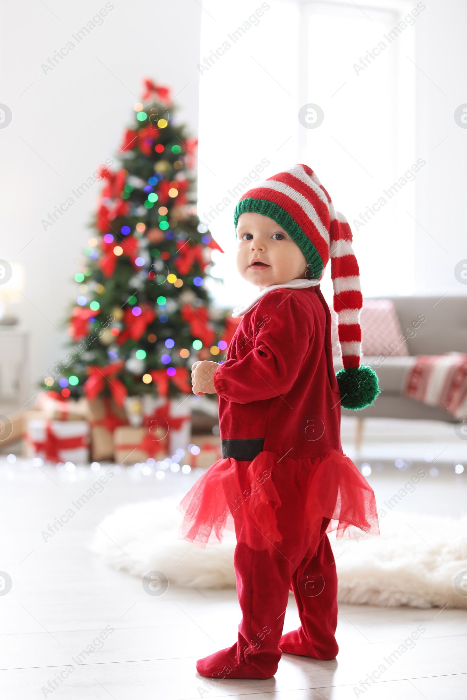 Photo of Cute baby in Christmas costume at home