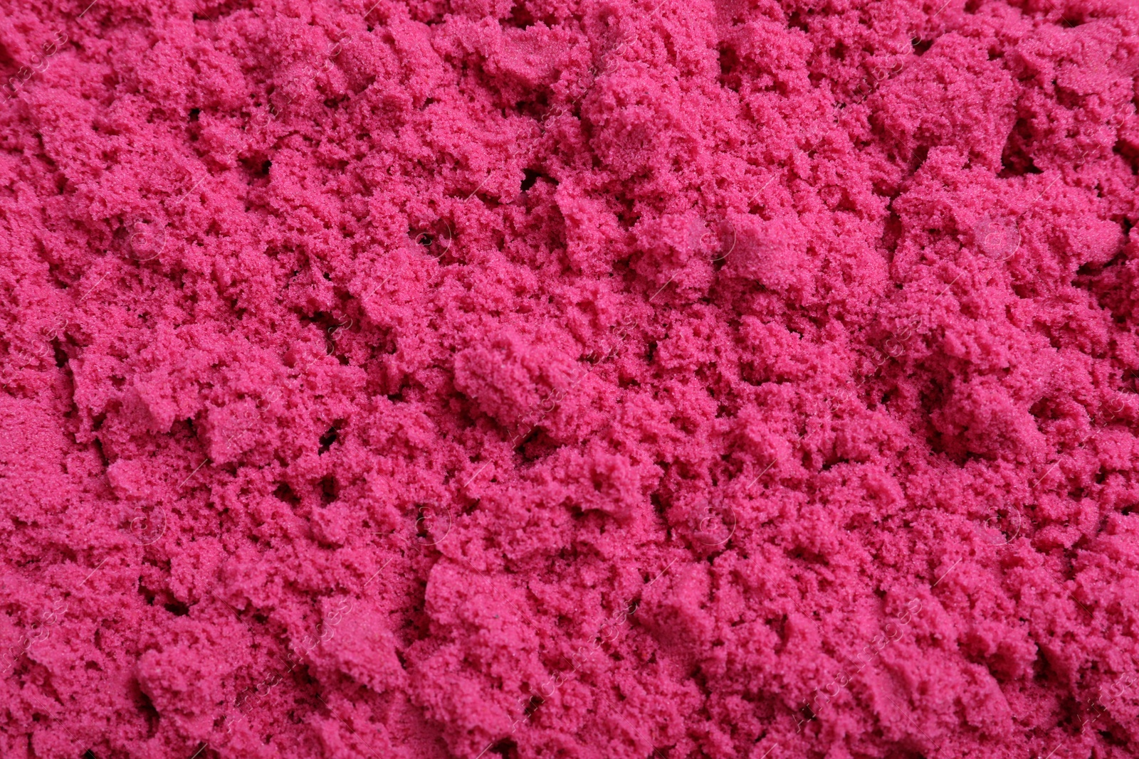 Photo of Pink kinetic sand as background, closeup view