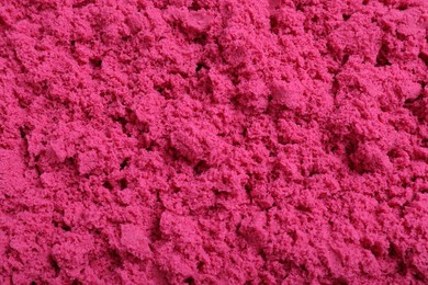 Pink kinetic sand as background, closeup view
