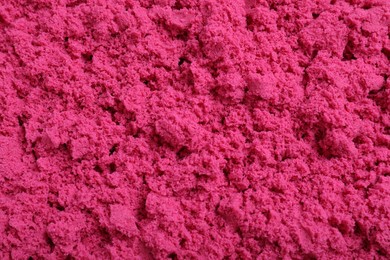 Photo of Pink kinetic sand as background, closeup view