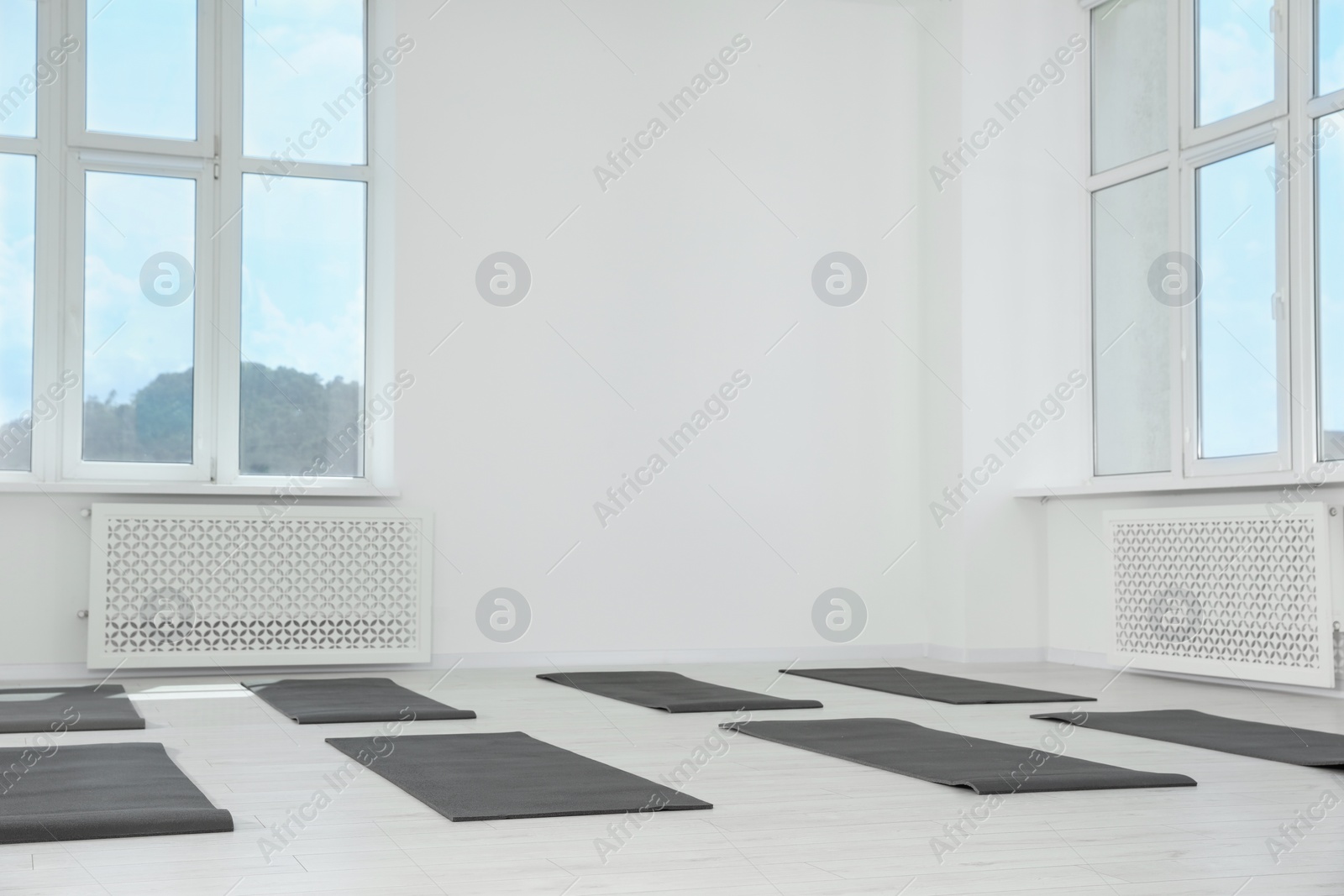 Photo of Spacious yoga studio with exercise mats and big windows