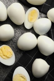 Photo of Peeled hard boiled quail eggs on grey table, flat lay