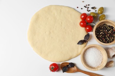 Photo of Fresh pizza dough and products on white background, flat lay. Space for text