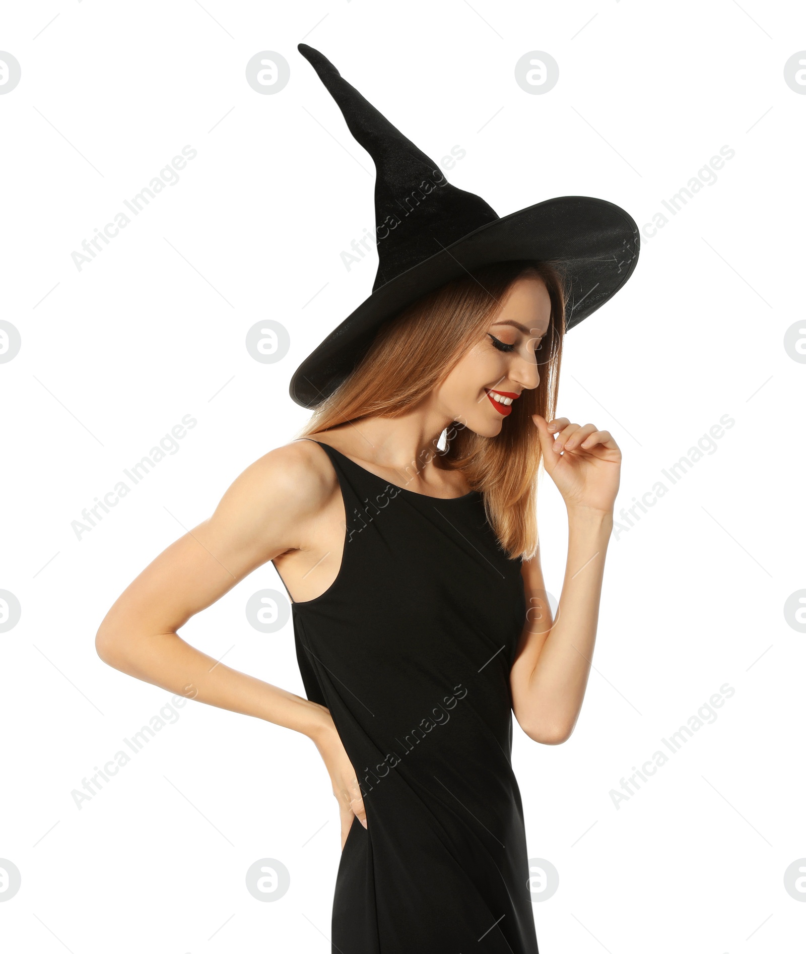 Photo of Beautiful young woman wearing witch costume for Halloween party on white background