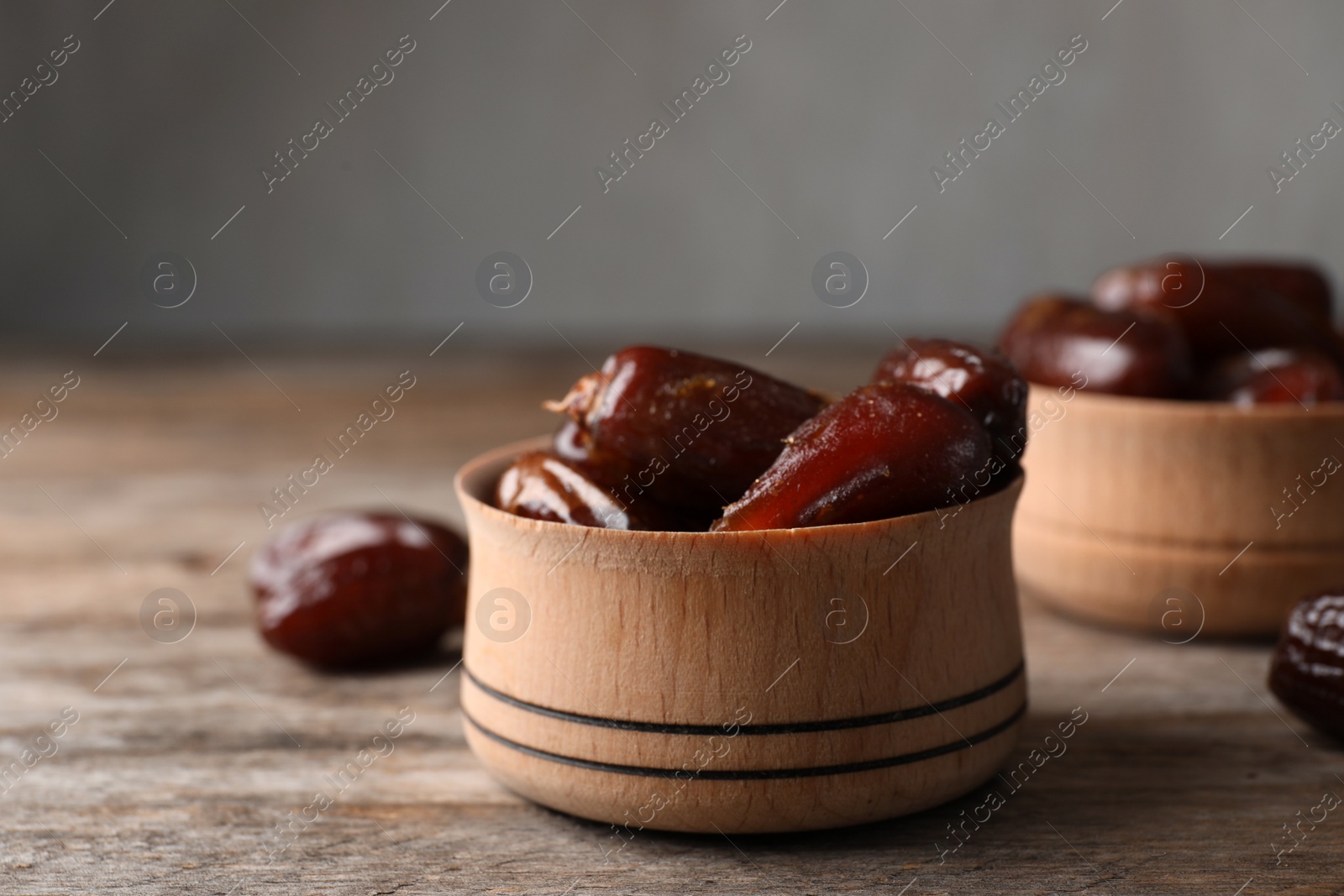 Photo of Bowl with sweet dates on table, space for text. Dried fruit as healthy snack