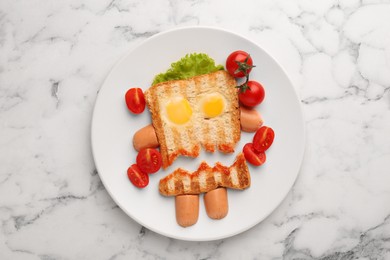 Cute monster sandwich with cherry tomatoes, fried eggs and sausages on white marble table, top view. Halloween snack
