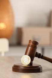 Photo of Law concept. Gavel and bitcoin on wooden table, space for text