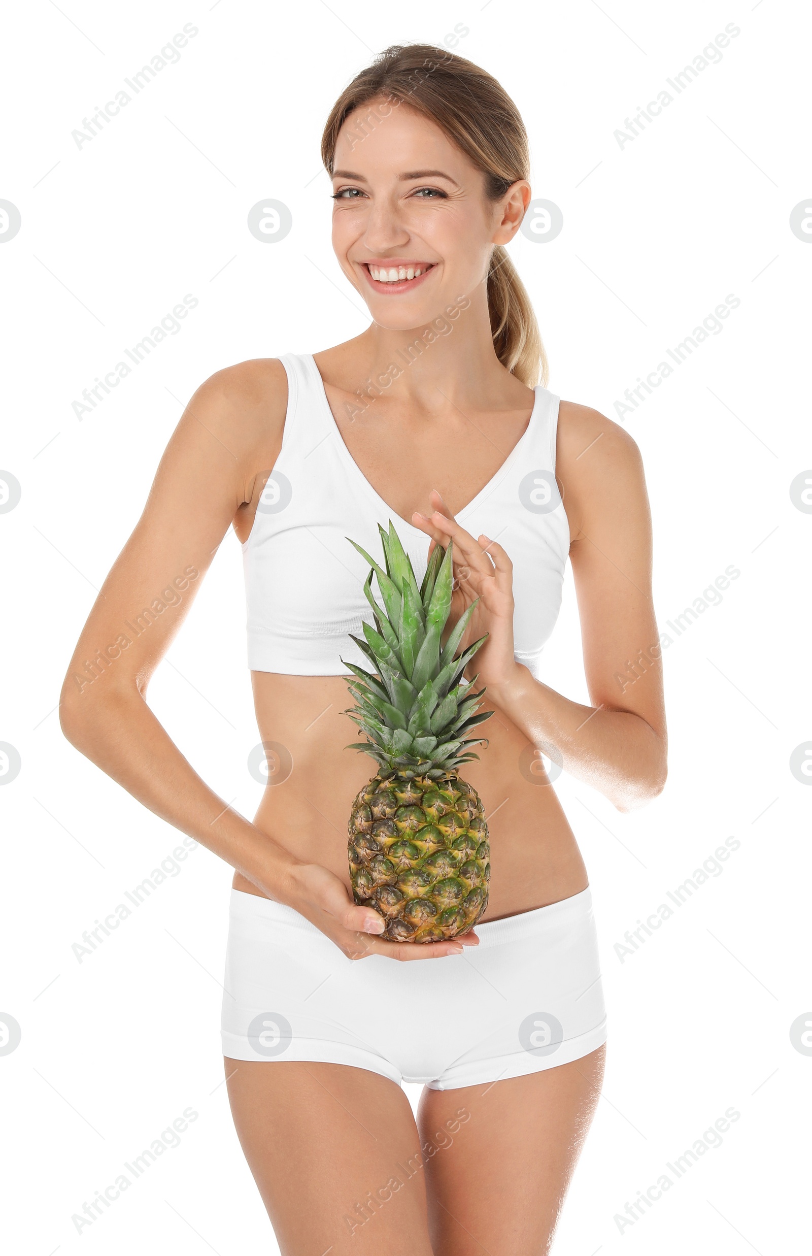 Photo of Happy slim woman in underwear holding pineapple on white background. Weight loss diet
