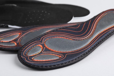 Closeup view of orthopedic insoles on light gray background