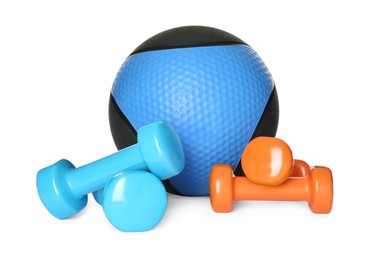 Medicine ball and dumbbells on white background