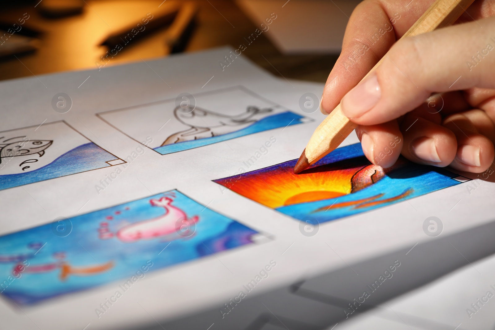 Photo of Woman drawing cartoon sketch in storyboard at workplace, closeup. Pre-production process