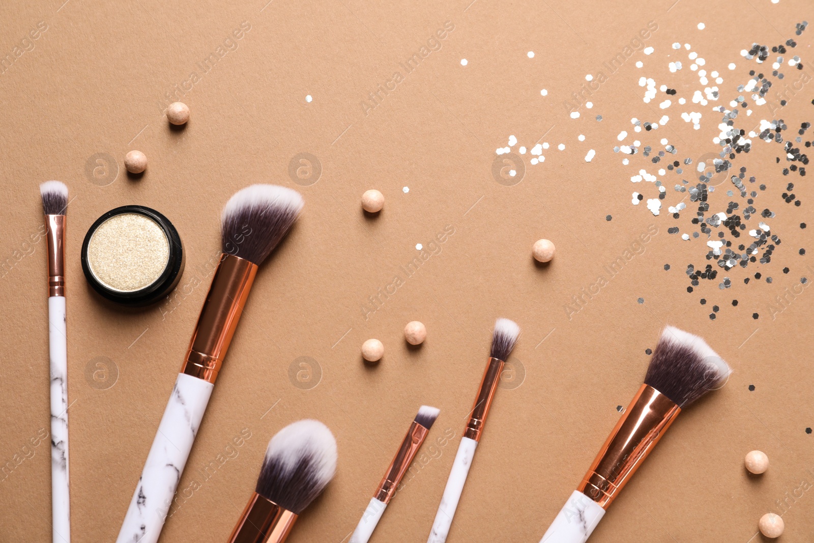 Photo of Flat lay composition with makeup brushes on brown background