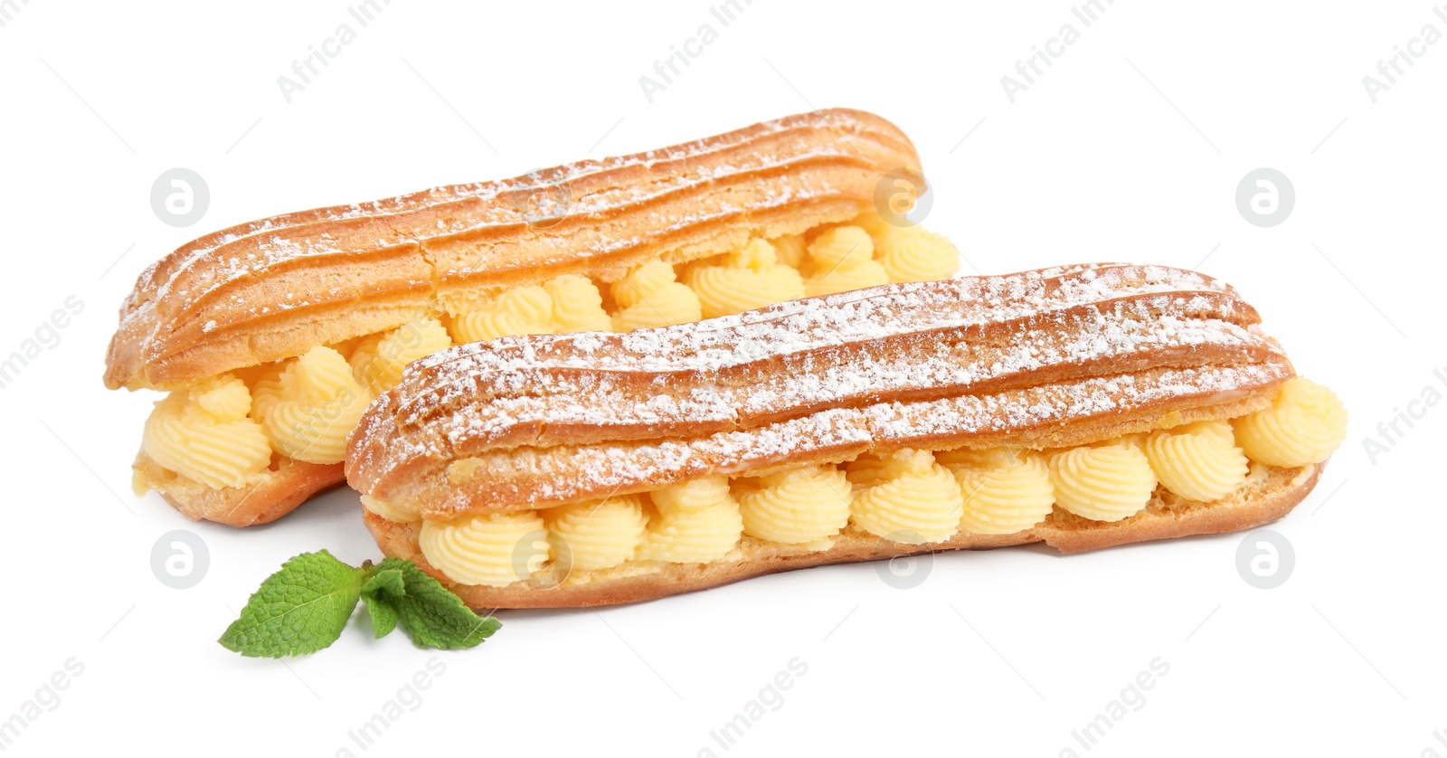 Photo of Delicious eclairs filled with cream and mint isolated on white