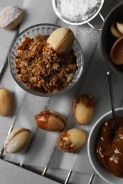 Photo of Delicious walnut shaped cookies with condensed milk on grey table, flat lay